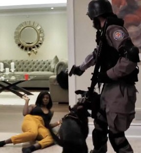 People dressed in gear emulating Toronto Police enter a home on in a video posted to YouTube Jan. 4, 2019.