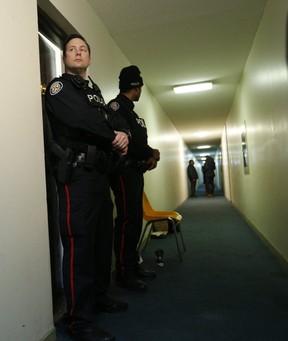 Two Toronto Police officer’s guard the eighth-floor apartment where the city’s fourth homicide of the year occurred at 100 Dundalk Dr. on Friday, Jan. 12, 2019. (Jack Boland/Toronto Sun/Postmedia Network)