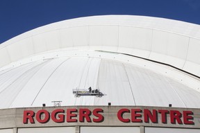 Workmen atop Toronto’s Rogers Centre roof on Thursday, Jan. 10, 2019. (Stan Behal/Toronto Sun/Postmedia Network)