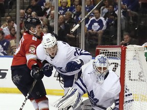 Panthers’ Jayce Hawryluk (left) collides with Maple Leafs’ Travis Dermott (centre) as Leafs goaltender Garret Sparks looks 
on during Friday’s game in Sunrise, Fla. It’s possible Sparks might not get another start until Feb. 1 in Detroit. (AP PHOTO)