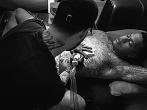 Canadian tattoo artist Levi Reimer goes to work on Blue Jays pitcher Marcus Stroman recently. Reimer stayed at Stroman’s house in Tampa, Fal.,  for five days while working on the tattoo Christopher Untalan/photos