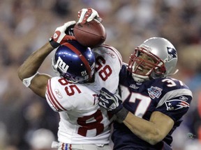 FILE - In this Feb. 3, 2008, file photo, New York Giants receiver David Tyree (85) catches a 32-yard pass in the clutches of New England Patriots safety Rodney Harrison (37) during the fourth quarter of the NFL football Super Bowl XLII in Glendale, Ariz. The Giants won 17-14. (AP Photo/Gene Puskar, File)