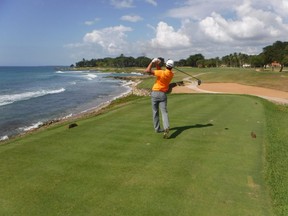 Taking a shot as the ocean waves kiss the shore at Teeth of the Dog golf course at Casa de Campo in the Dominican Republic. (Tim Baines photo)