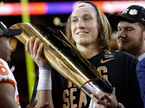 Clemson's Trevor Lawrence holds the trophy after the NCAA college football playoff championship game against Alabama, Monday, Jan. 7, 2019, in Santa Clara, Calif.