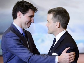 Prime Minister Justin Trudeau embraces Indigenous Services Minister Seamus O'Regan at a swearing in ceremony at Rideau Hall in Ottawa on Jan. 14, 2019.
