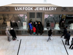 Onlookers take in scene at Lukfook Jewellery at Markville mall after a smash and grab robbery in Toronto on Monday December 31, 2018.