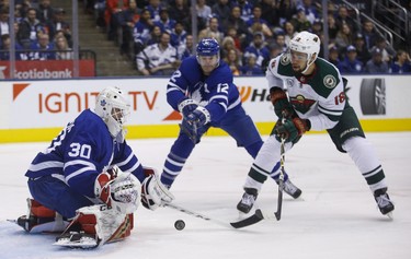 Toronto Maple Leafs Michael Hutchinson G (30) makes a save on Minnesota Wild Jason Zucker LW (16) close in during second period in Toronto on Thursday January 3, 2019. Jack Boland/Toronto Sun/Postmedia Network