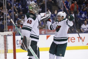 Minnesota Wild Jared Spurgeon D (46) celebrates the win with teammate Devan Dubnyk G (40) who saved 38 of 41 shots during third period in Toronto on Thursday January 3, 2019. Jack Boland/Toronto Sun/Postmedia Network