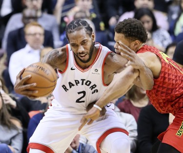 Toronto Raptors forward Kawhi Leonard (2) takes control of the ball beside Atlanta Hawks guard Trae Young (11) in Toronto, Ont. on Tuesday January 8, 2019. The Toronto Raptors host the Atlanta Hawks. Veronica Henri/Toronto Sun/Postmedia Network