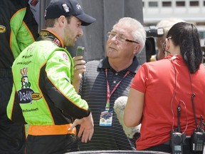 Dean McNulty, centre, speaks to Oakville driver James Hinchcliffe for the Toronto Sun during the Honda Indy Toronto July 16, 2011. (Jack Boland/Toronto Sun)