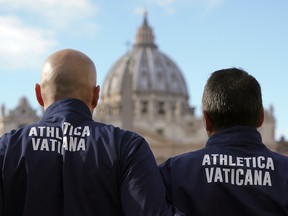 Athletes of the Athletica Vatican team pose for the media in front of St. Peter's Basilica, at the Vatican, Thursday, Jan. 10, 2019. (AP Photo/Andrew Medichini)