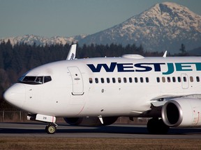 A pilot taxis a Westjet Boeing 737-700 plane to a gate after arriving at Vancouver International Airport in Richmond, B.C.