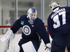 Winnipeg Jets goaltenders Laurent Brossoit (left) and Connor Hellebuyck horse around during an informal workout at Bell MTS Iceplex back in September. With the Winnipeg Jets slated to essentially play every second night between now and the end of the NHL regular season, both netminders will be kept busy.