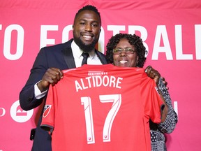 Toronto FC striker Jozy Altidore (left), poses for photographers with his mother, Giselle Altidore, during Thursday's news conference. (THE CANADIAN PRESS)