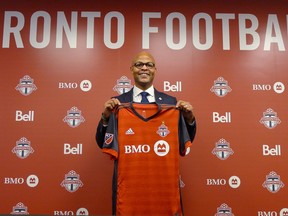 Toronto FC's new general manager Ali Curtis holds up a club jersey at a news conference introducing him last month. (THE CANADIAN PRESS)