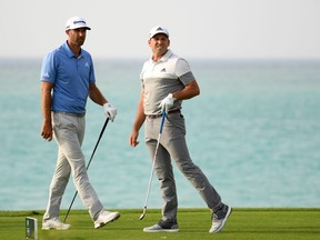 Dustin Johnson of the USA and Sergio Garcia of Spain on the 17th tee during the first round of the Saudi International at the Royal Greens Golf & Country Club on January 31, 2019 in King Abdullah Economic City, Saudi Arabia. (Photo by Ross Kinnaird/Getty Images)