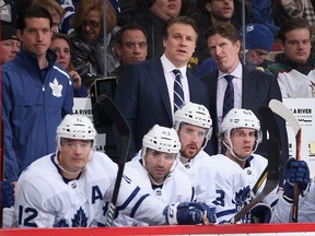 Assistant Leafs coach Jim Hiller and head coach Mike Babcock watch from the bench during Saturday's game against the Arizona Coyotes.