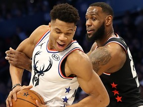 Giannis Antetokounmpo, left, of the Milwaukee Bucks and Team Giannis fights to keep the ball against LeBron James of the L.A. Lakers and Team LeBron in the third quarter during the NBA All-Star game as part of the 2019 NBA All-Star Weekend at Spectrum Center on Feb. 17, 2019 in Charlotte, North Carolina.  (Streeter Lecka/Getty Images)