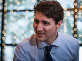 Prime Minister Justin Trudeau campaigns with Richard T. Lee (not seen) -- the Liberal candidate in the Burnaby South byelection -- at a cafe in Burnaby, B.C., on Feb. 11, 2019. (The Canadian Press)