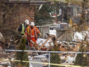 Workers are pictured in rubble at the scene of a house explosion in Caledonia Village. (Ernest Doroszuk, Toronto Sun)