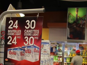 Shoppers check out the selection of beer at a Gatineau corner store Friday, June 28, 2013