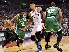 Boston Celtics guard Kyrie Irving dribbles around Raptors guard Danny Green during Tuesday's game. (THE CANADIAN PRESS)
