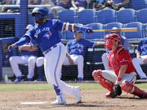 Blue Jays’ Vladimir Guerrero Jr. follows through with a double against the Phillies in Dunedin yesterday. Vlad went 1-for 3 in the Jays’ 11-5 loss.  AP
