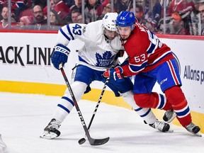 Nazem Kadri  of the  Maple Leafs and Victor Mete  of the  Canadiens battle for the puck during a game at the Bell Centre.  (Photo by Minas Panagiotakis/Getty Images)