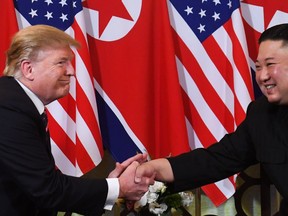 U.S. President Donald Trump (L) speaks with North Korea's leader Kim Jong Un during a meeting at the Sofitel Legend Metropole hotel in Hanoi on February 27, 2019. (Photo by Saul LOEB/AFP)