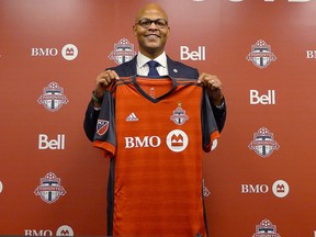 Toronto FC general manager Ali Curtis holds up a club jersey at a news conference introducing him in Toronto, Thursday, Jan.3, 2019. (THE CANADIAN PRESS/Neil Davidson)