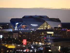 The sun sets behind Mercedes-Benz Stadium ahead of Sunday's Super Bowl LIII between the Los Angeles Rams and New England Patriots in Atlanta, Friday, Feb. 1, 2019. (AP Photo/David Goldman)