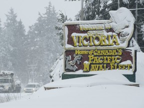 Vehicles make their way along the snow-covered highway in Victoria, B.C., Tuesday, Feb. 12, 2019.