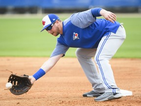 Toronto Blue Jays infielder Justin Smoak catches the ball at first base during a drill at baseball spring training in Dunedin, Fla., THE CANADIAN PRESS/Nathan Denette