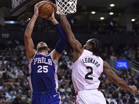 Philadelphia 76ers guard Ben Simmons (25) drives to the basket and is fouled by Toronto Raptors forward Kawhi Leonard (2) during second half NBA basketball action in Toronto on Oct. 30, 2018. (NATHAN DENETTE/The Canadian Press files)