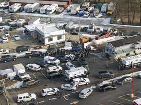 First responders and emergency vehicles are gathered near the scene of a shooting at an industrial park in Aurora, Ill., on Friday, Feb. 15, 2019. (Bev Horne/Daily Herald via AP)