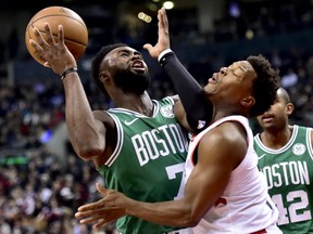 Boston Celtics guard Jaylen Brown (7) causes an offensive foul on Toronto Raptors guard Kyle Lowry (7) during first half NBA basketball action in Toronto on Tuesday, Feb. 26, 2019. THE CANADIAN PRESS/Frank Gunn