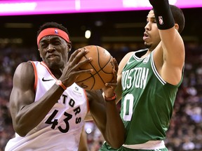 Raptors’ Pascal Siakam (left) drives to the basket against the Celtics’ forward Jayson Tatum. Siakam has taken a big step up in his game this season and has a good chance a winning the most improved player award.  The Canadian Press