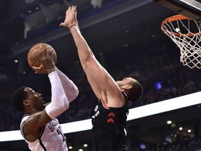Toronto Raptors centre Marc Gasol defends as Brooklyn Nets forward Rondae Hollis-Jefferson (24) shots during first half last night in TorontoTHE CANADIAN PRESS/Frank Gunn