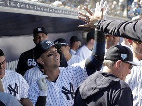 New York Yankees' Troy Tulowitzki celebrates in the dugout after hitting a solo home run in the first inning during a spring training baseball game against the Toronto Blue Jays on Monday. The Yankees won 3-0. AP Photo/Lynne Sladky)