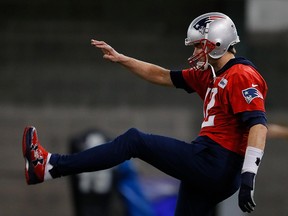 Tom Brady of the New England Patriots stretches during Super Bowl LIII practice at Georgia Tech Brock Practice Facility on Feb. 1, 2019 in Atlanta, Ga.