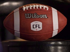 A football with the new CFL logo sits on a chair during a press conference in Winnipeg,  Nov. 27, 2015.