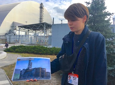 Chornobyl Tour guide Helen Ludekha shows an image of what Reactor #4 looked like prior to the 1986 nuclear disaster at the Chornobyl power plant in Ukraine. (Chris Doucette/Toronto Sun/Postmedia Network)