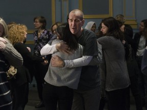 Doug Fallon, the father of one of last year's Danforth shooting victims, Reese, hugs Noor Samiel, who spoke passionately about her best friend who died that night. Their families & their friends gathered at the Danforth Music Hall to call for tighter gun controls in Canada , on Friday, Feb. 22, 2019. (Stan Behal/Toronto Sun/Postmedia Network)