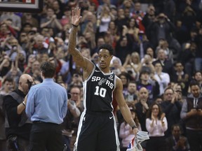 San Antonio Spurs’ DeMar DeRozan comes out to salute the fans in Toronto during a break 
in the first quarter on Friday night against his former team, the Raptors. (JACK BOLAND/TORONTO SUN)