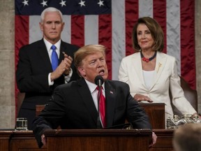 U.S. President Donald Trump gives his State of the Union address to a joint session of Congress, Tuesday, Feb. 5, 2019 at the Capitol in Washington, as Vice President Mike Pence, left, and House Speaker Nancy Pelosi look on.