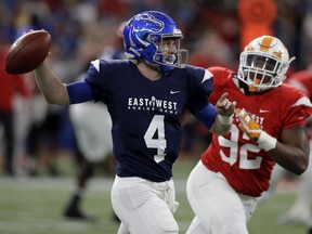 West quarterback Brett Rypien (4), of Boise State, throws a pass as he is pressured by East defensive lineman Kyle Lawrence Phillips (92), of Tennessee, during the first half of the East West Shrine college football game Saturday, Jan. 19, 2019, in St. Petersburg, Fla.