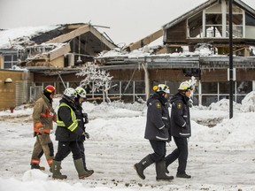 A firefighter and investigators from the Office of the Fire Marshall at the aftermath of the fire at the Agincourt Recreation Centre, near Midland Ave. and Sheppard Ave E. in Toronto, Ont. on Saturday, Feb. 2, 2019. (Ernest Doroszuk/Toronto Sun/Postmedia)