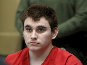 In this Aug. 15, 2018 file photo, Florida school shooting suspect Nikolas Cruz listens during a status check on his case at the Broward County Courthouse in Fort Lauderdale, Fla.