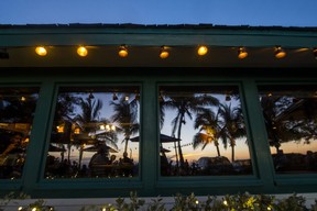 The sunset is reflected in the window of the Mucky Duck Neighbourhood Pub, on Captiva Island. Ernest Doroszuk/Toronto Sun