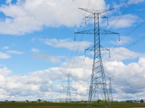 A line of hydro towers reach into the distance, contrasting the rural farmland landscape of Bruce County, Ontario, Canada